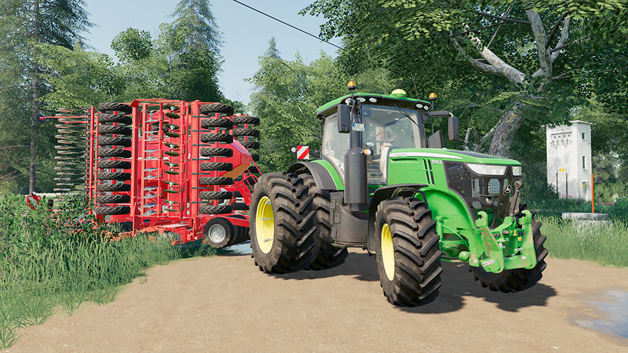 Close up of a John Deere 7R tractor, pulling a Horsch seeder