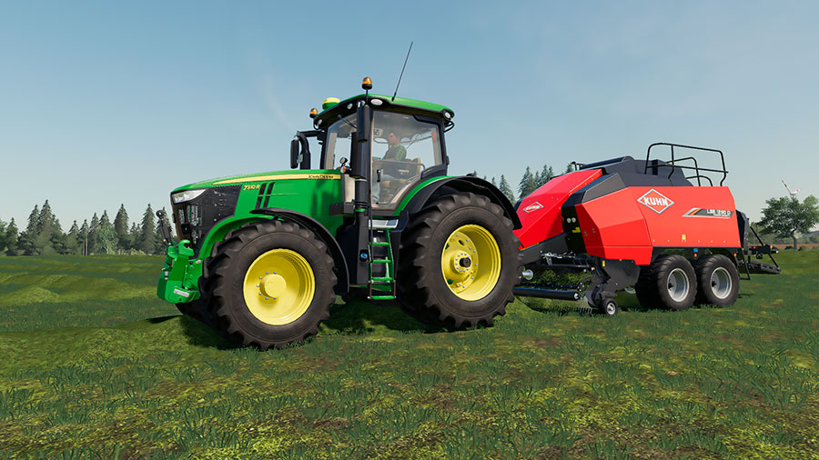 Green John Deere 7R pulling a Kuhn square baler