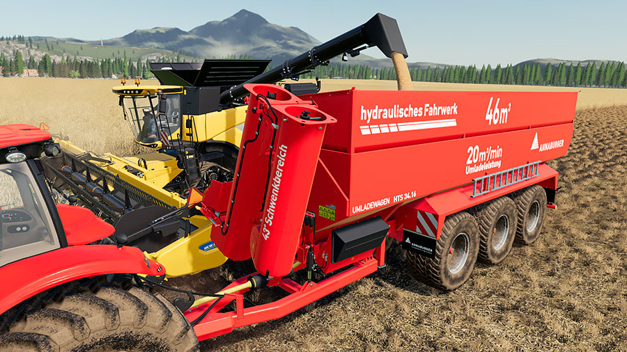 New Holland harvesters overloading grain into the Annaburger auger wagon.