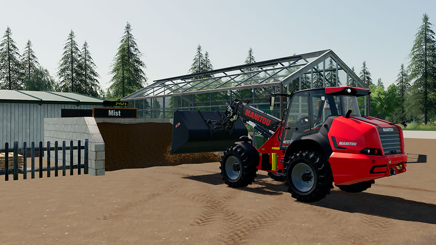 A Manitou telehandler unloads manure near the nursery's manure clamp