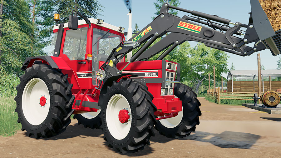 IH C-Series 1056 XL tractor using a Stoll Robust F30 front loader to transport manure