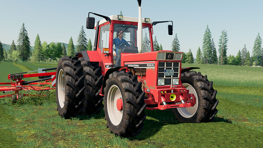 International Harvester 1056 XL tractor pulling a Kuhn twin rotor rake