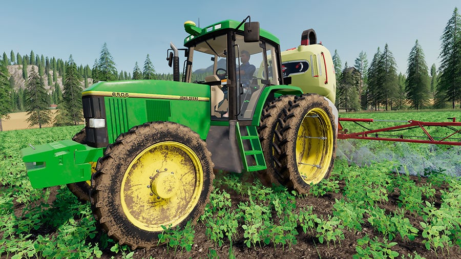 John Deere 6000 Premium spraying liquid fertilizer in a field of soybeans