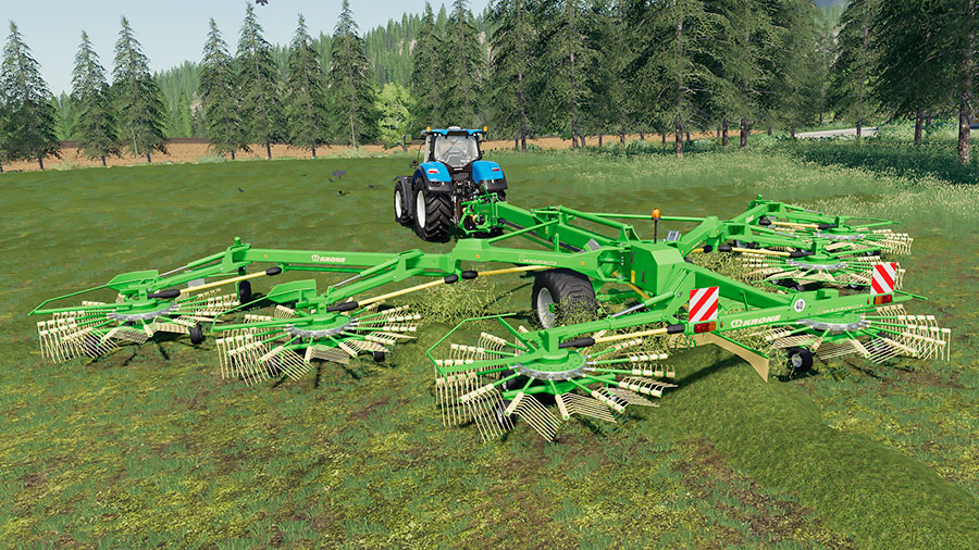 The Krone Swadro 2000 raking grass, creating swaths, pulled by a New Holland tractor