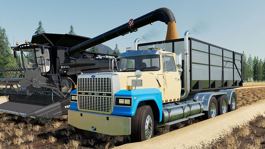 A Ford LTL9000 swap body truck unloading a Fendt Ideal combine harvester