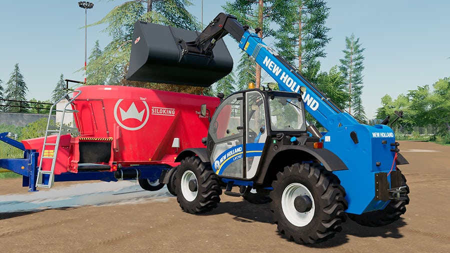 A New Holland LM 7.42 unloading silage into a TMR mixer trailer