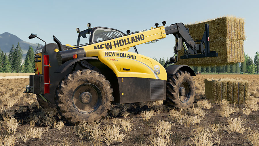 A New Holland TH 7.42 stacking straw bales in a field