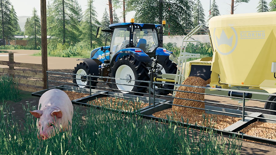 A SiloKing feed mixer unloading pig food into a feeding trough