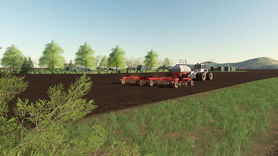 A Big Bud tractor sowing in a field on the Welker Farms map